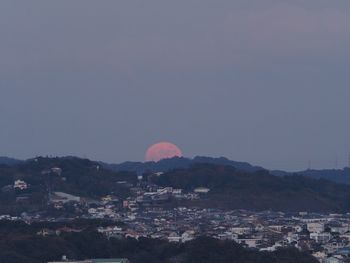 Townscape by mountain against sky