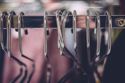 Close up of coathangers hanging on rack