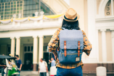 Rear view of woman standing on street