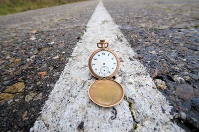 Close-up of clock on road