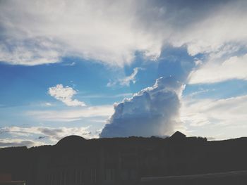 Low angle view of silhouette buildings against sky