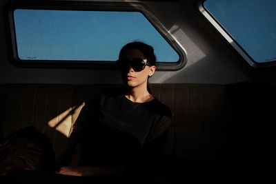 Young woman sitting in car