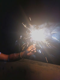 Low angle view of firework display at night