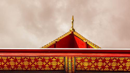 Low angle view of temple against cloudy sky