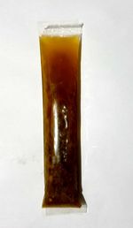 Close-up of beer glass on table against white background