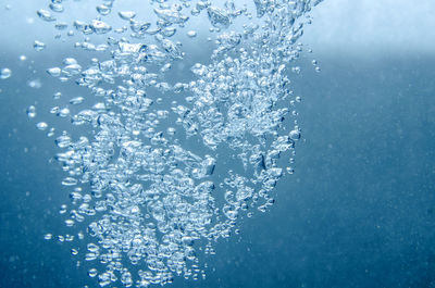 Close-up of bubbles against blue background