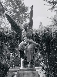 Statue of buddha against trees