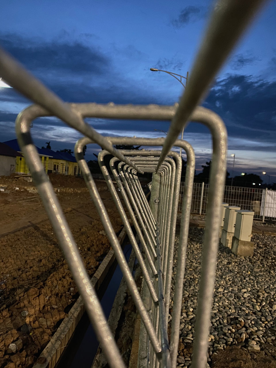 CLOSE-UP OF METAL FENCE AGAINST SKY