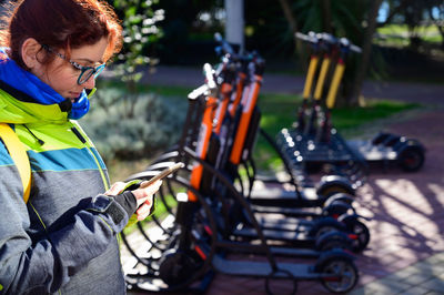 Side view of young woman using mobile phone