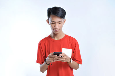 Potrait of young asian student playing a smartphone