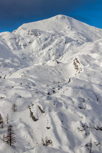 Scenic view of snow covered mountains against sky