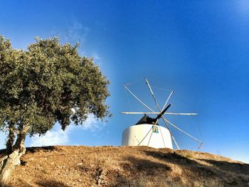 Low angle view of traditional windmill against sky