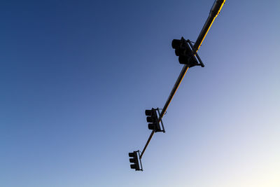 Low angle view of street light against clear blue sky