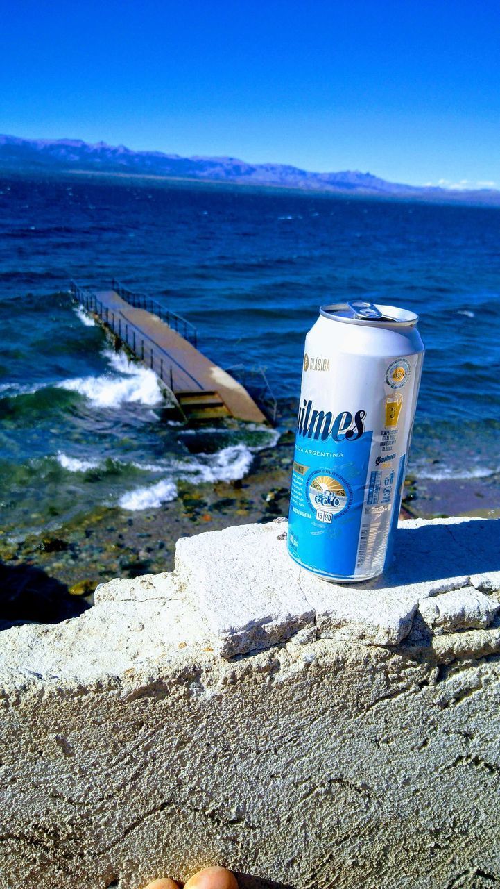 INFORMATION SIGN ON BEACH AGAINST SKY