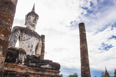 Low angle view of statue against cloudy sky