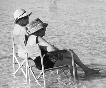 People sitting on chair at beach