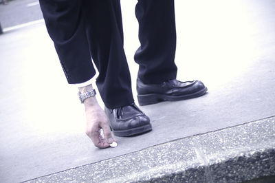 Low section of men standing on road
