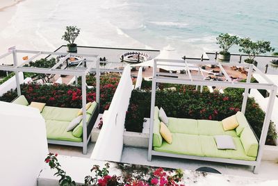 High angle view of potted plants on table by sea