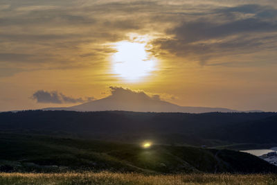 Scenic view of field against sky during sunset