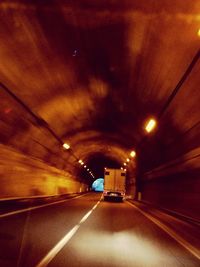 Road in illuminated tunnel