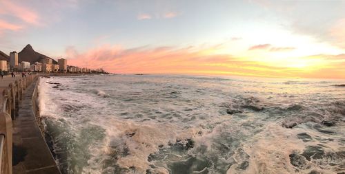 Scenic view of beach against sky during sunset