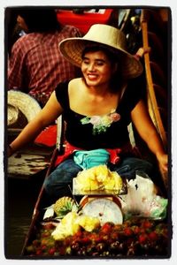 Portrait of young woman sitting on table