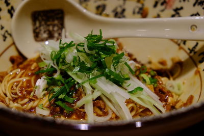 Close-up of noodles with spring onions served in bowl