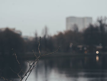 Scenic view of lake against sky in city