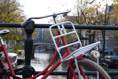 Close-up of bicycle parked by railing in city