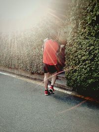 Rear view of woman walking on road