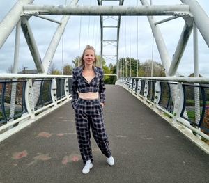 Portrait of smiling man standing on bridge