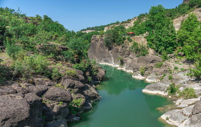 Scenic view of waterfall against sky