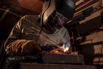 Close-up of welder working at factory