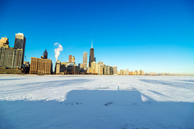 Frozen lake michigan against urban skyline