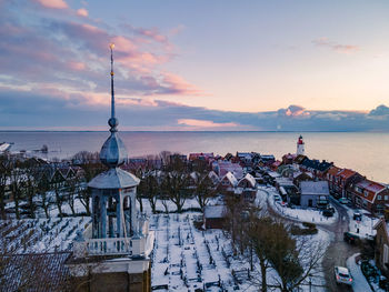 High angle view of building by sea during sunset