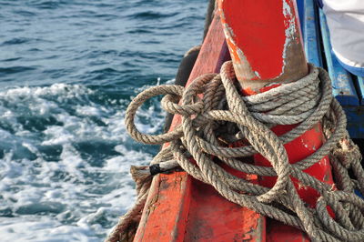 Close-up of rope tied to boat moored in sea