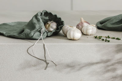 High angle view of hand holding rope on table