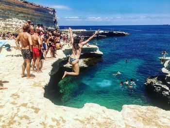 People at beach against sky