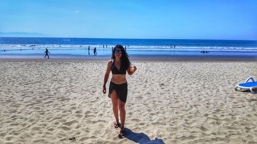 Full length of man on beach against sky