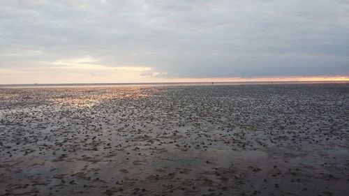 View of calm sea against cloudy sky