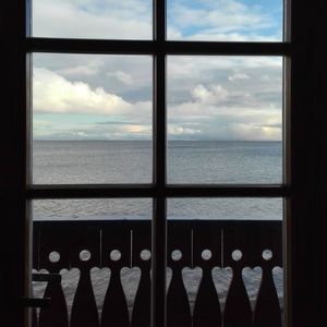 Close-up of sea against sky seen through window