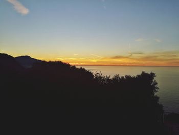 Scenic view of silhouette mountains against sky during sunset