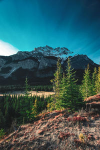 Scenic view of mountains against blue sky