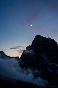 Scenic view of silhouette mountains against sky at night