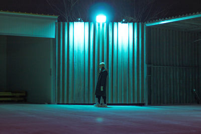 Man standing in illuminated room