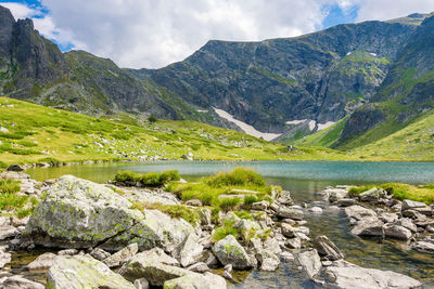 Scenic view of lake and mountains against sky