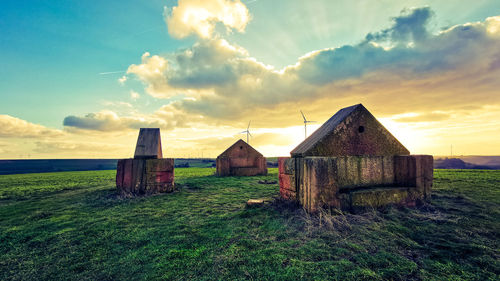 Built structure on field against sky