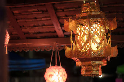 Low angle view of illuminated lantern hanging in building