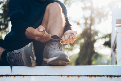 Low section of man sitting on floor