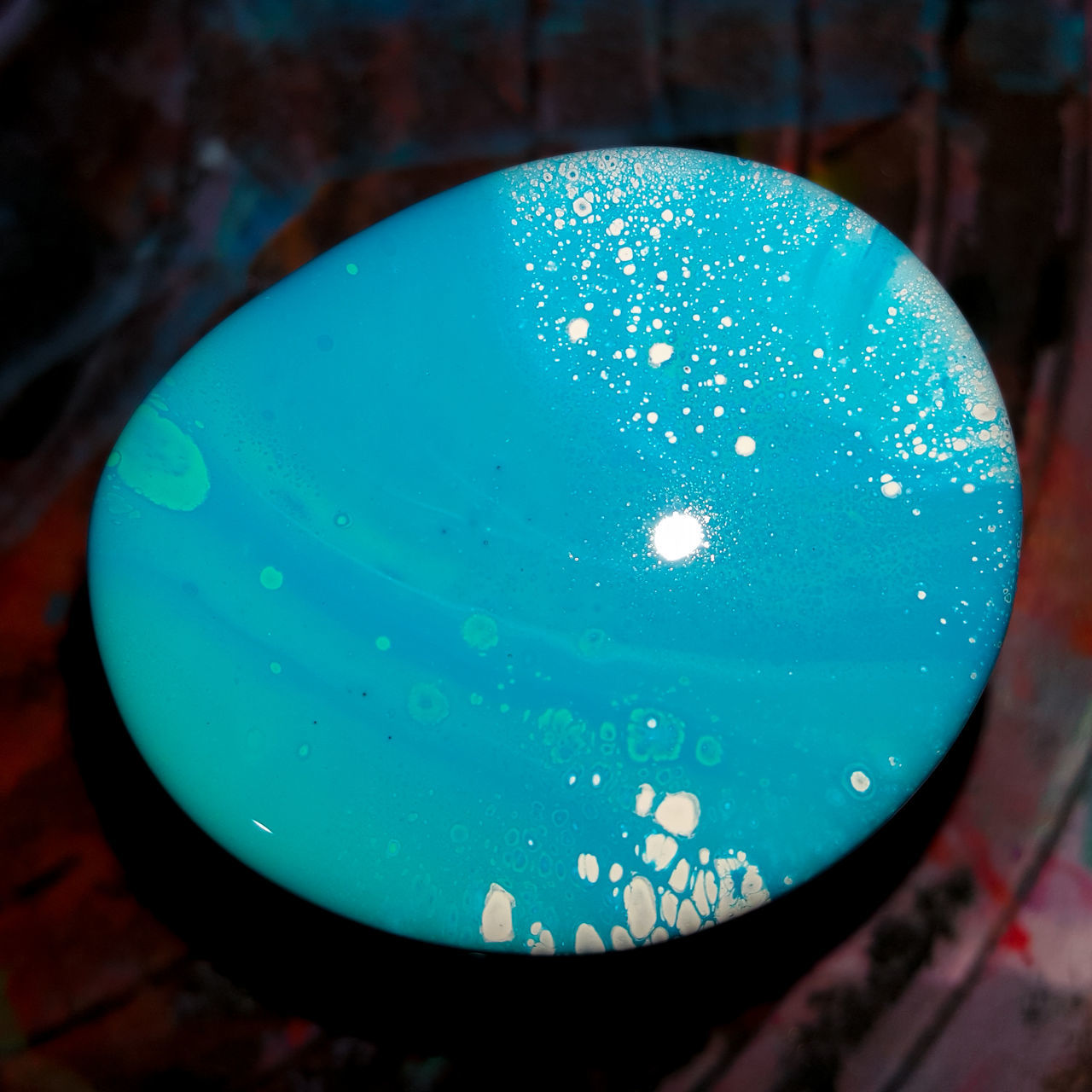 close-up, no people, blue, geometric shape, shape, drop, water, focus on foreground, circle, indoors, wet, green color, high angle view, still life, single object, pattern, nature, sphere, table, turquoise colored